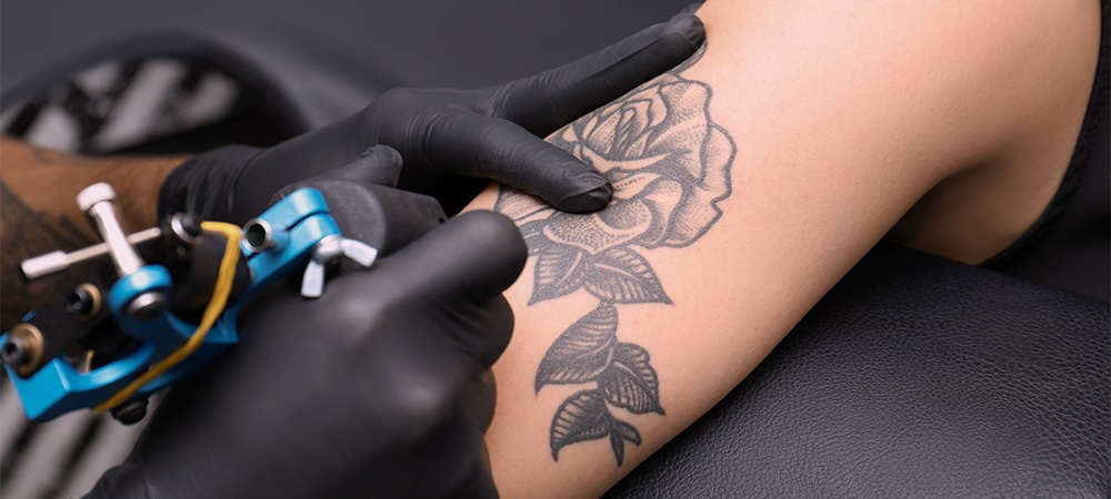 artist tattooing fine line tattoo
