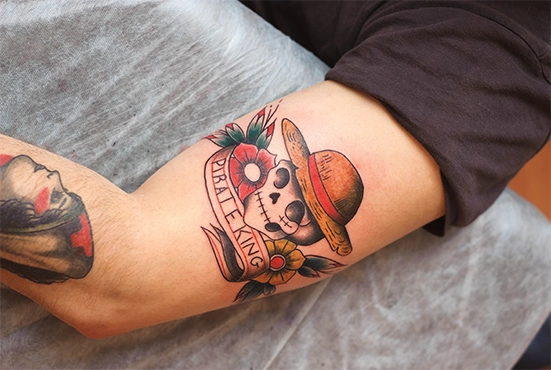 colorful skull tattoo on men arm