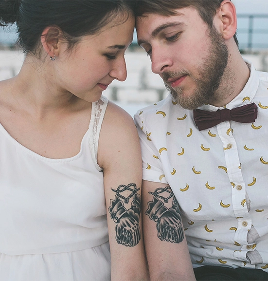 matching sleeve couple bond tattoos on young couple