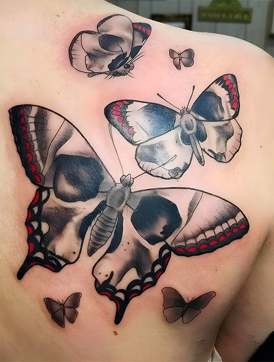 skull and butterfly tattoo on back side