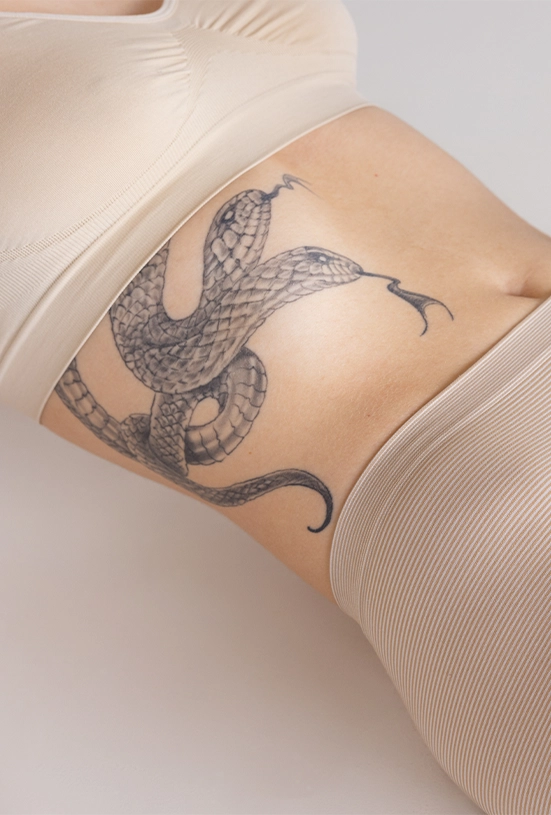 snake tattoo on girl belly