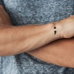 man on his wrist semi colon tattoo