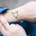 small colourful tattoo on men wrist