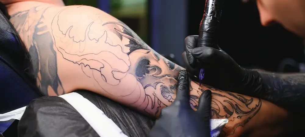 tattoo artist tattoo touch up on arm